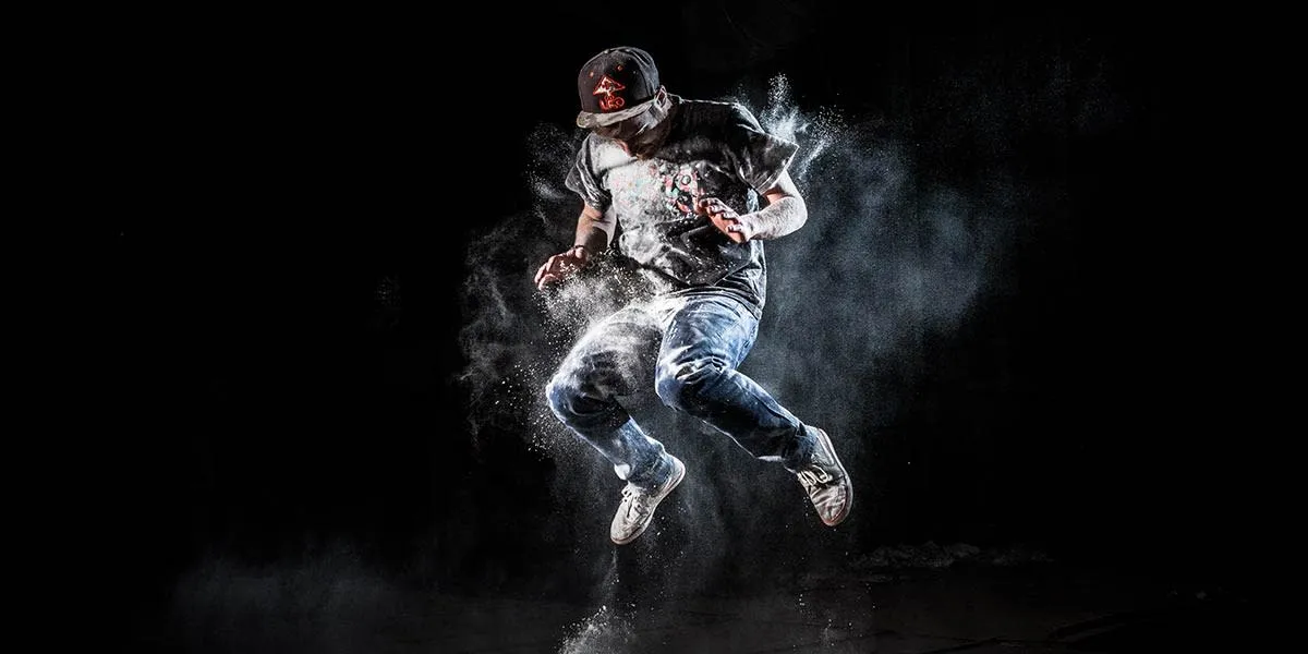 man jumping in white powder flash photography