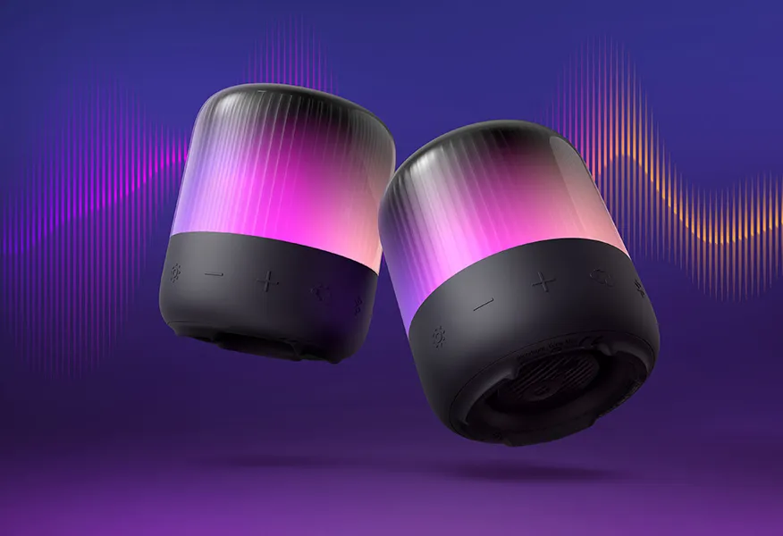 دو اسپیکر Soundcore Glow Mini با نور بنفش-صورتی در حال پخش موزیک با امواج صوتی